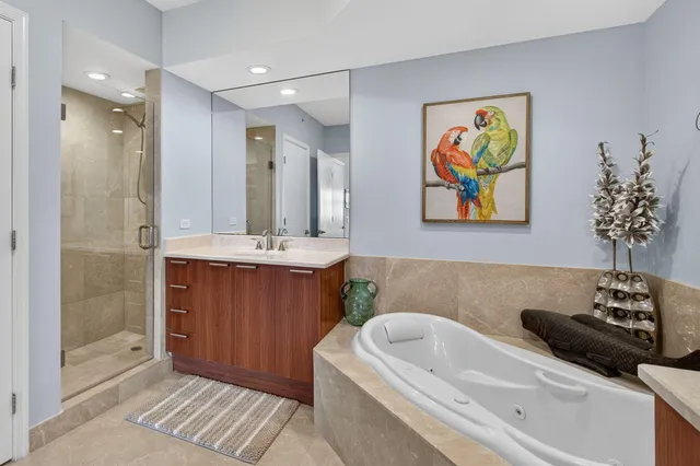 a bathroom with a tub sink and mirror