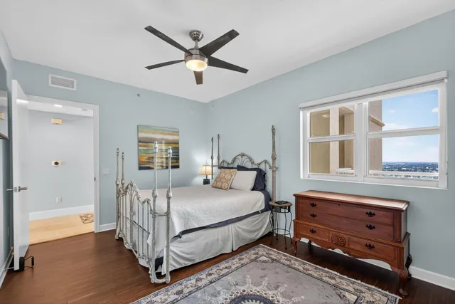 a bedroom with a bed a window and closet