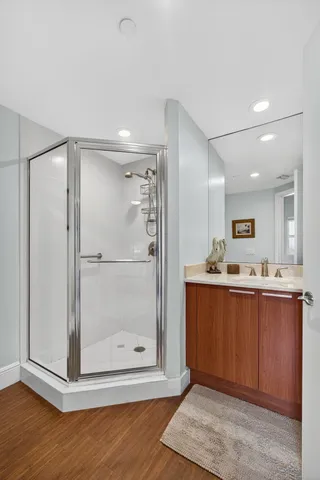 a bathroom with a glass shower door and a mirror