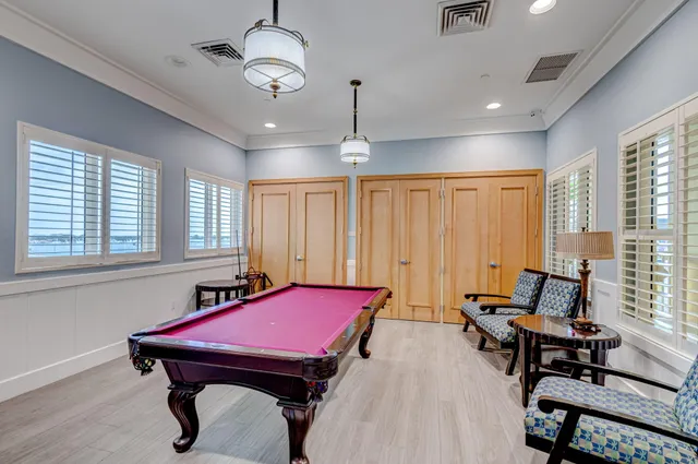 a room with furniture pool table and windows