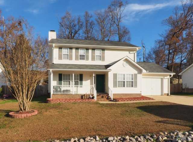 5645 Lighthall Lane Raleigh, NC 27604 - Photo 1 of 25 a front view of a house with a garden