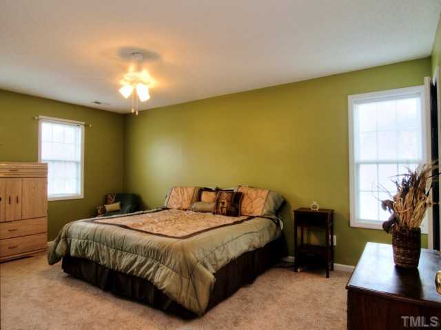5645 Lighthall Lane Raleigh, NC 27604 - Photo 11 of 25 a bedroom with a bed flat screen tv and window