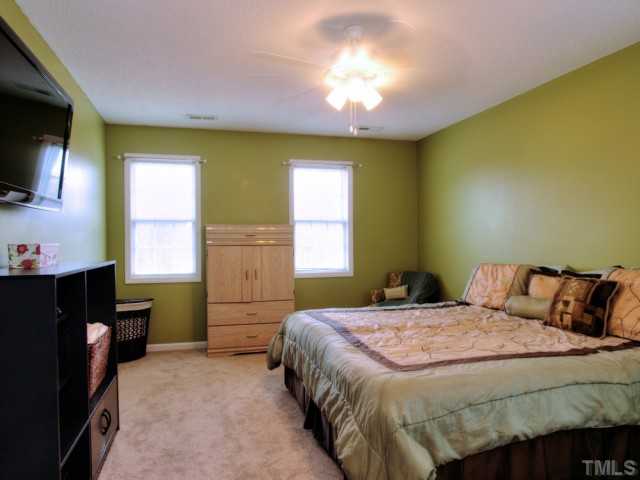 5645 Lighthall Lane Raleigh, NC 27604 - Photo 12 of 25 a bedroom with a bed and a flat screen tv