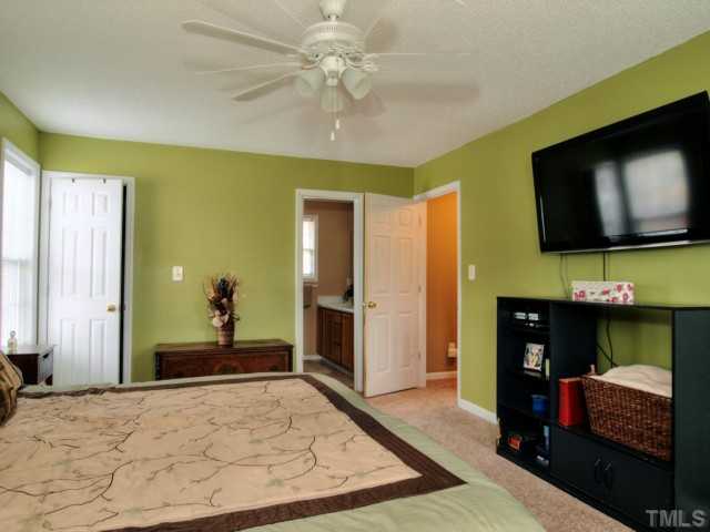 5645 Lighthall Lane Raleigh, NC 27604 - Photo 13 of 25 a bedroom with a bed and a flat screen tv