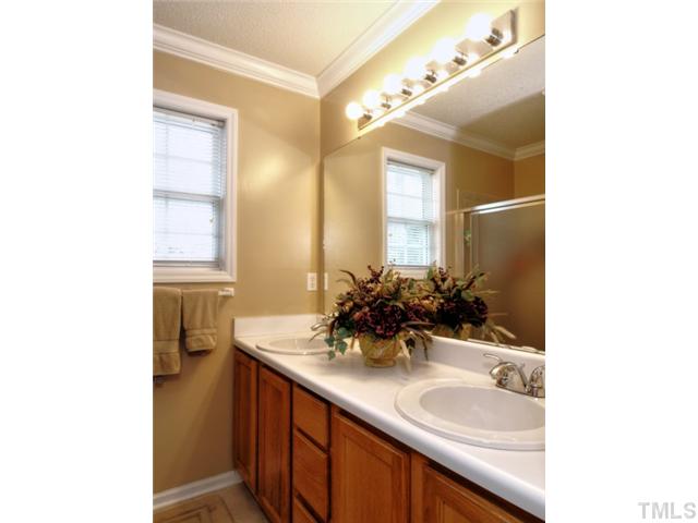 5645 Lighthall Lane Raleigh, NC 27604 - Photo 14 of 25 a bathroom with a granite countertop sink and a mirror