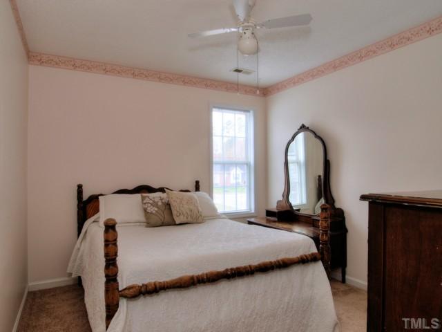 5645 Lighthall Lane Raleigh, NC 27604 - Photo 15 of 25 a bedroom with a large bed and a window