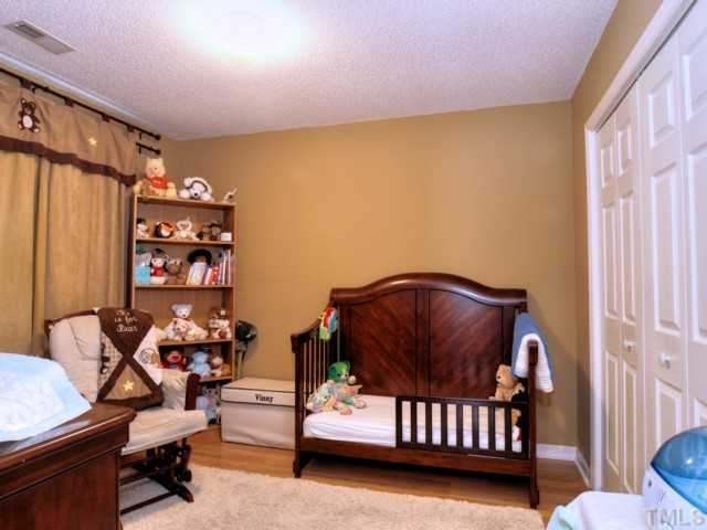 5645 Lighthall Lane Raleigh, NC 27604 - Photo 16 of 25 a bedroom with furniture and a window