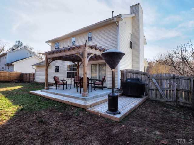 5645 Lighthall Lane Raleigh, NC 27604 - Photo 18 of 25 a front view of a house with garden and chairs