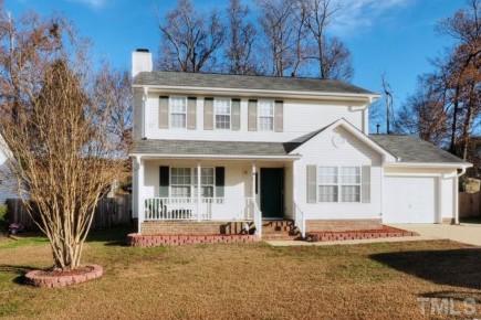 5645 Lighthall Lane Raleigh, NC 27604 - Photo 25 of 25 a view of a white house with a large tree and wooden fence