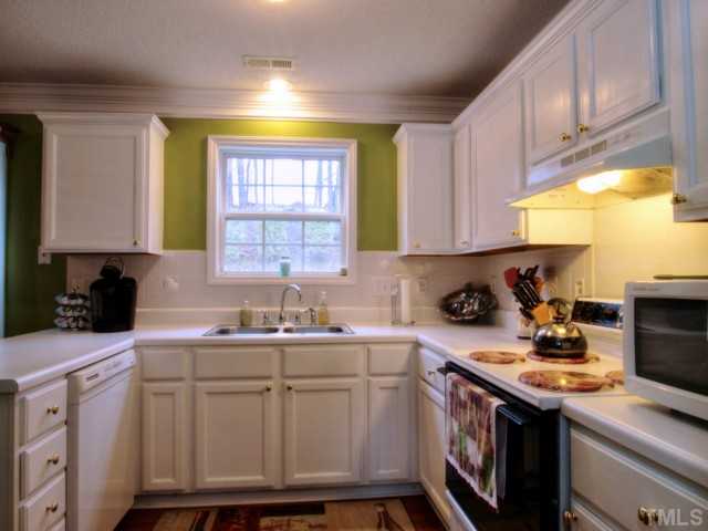 5645 Lighthall Lane Raleigh, NC 27604 - Photo 9 of 25 a kitchen with a sink cabinets and window