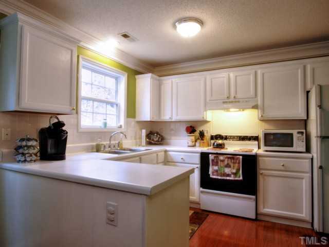 5645 Lighthall Lane Raleigh, NC 27604 - Photo 10 of 25 a kitchen with a sink stove top oven and cabinets