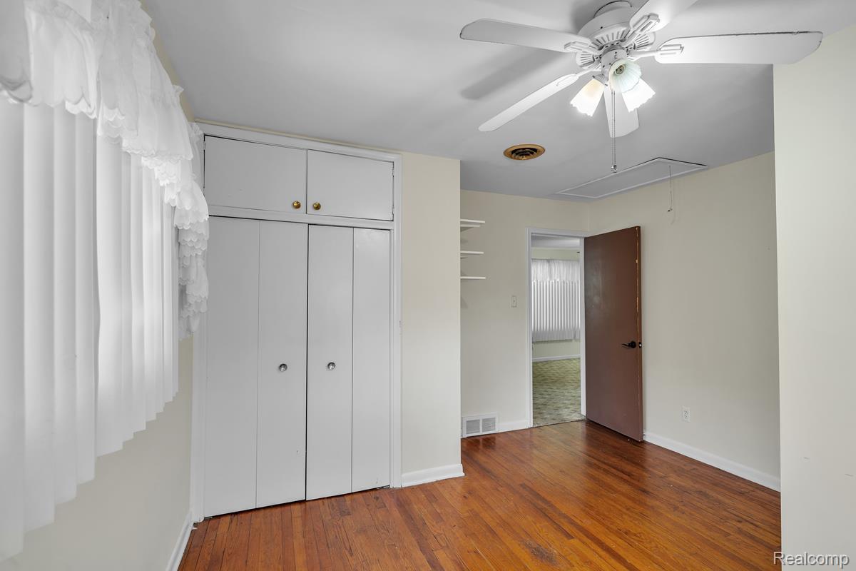 8620 Stephens Road Warren, MI 48089 - Photo 13 of 15 Unfurnished bedroom with light wood-type flooring, a ceiling fan, and a closet