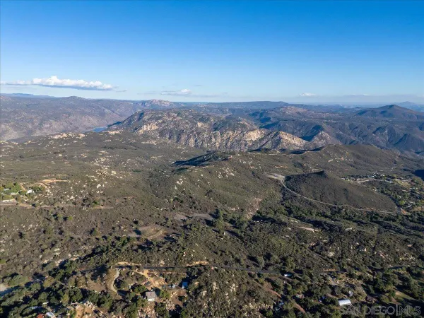 an aerial view of house with yard and mountain in the back