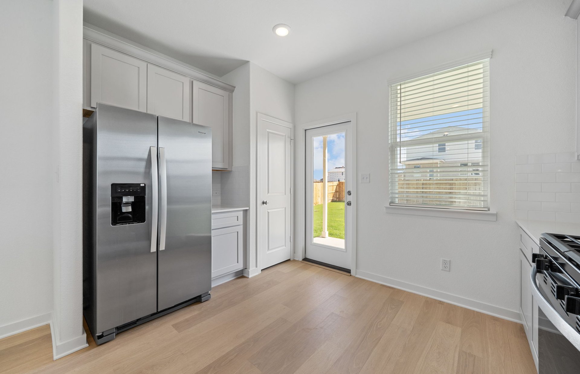 608 Rubber Tree Way Buda, TX 78610 - Photo 2 of 29 a view of a refrigerator in kitchen and a window in a room