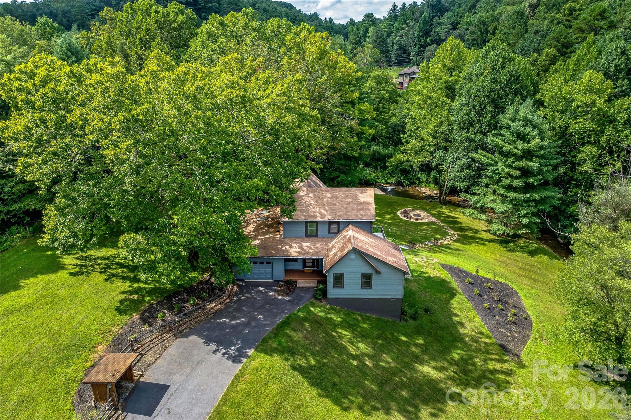 an aerial view of a house with a yard