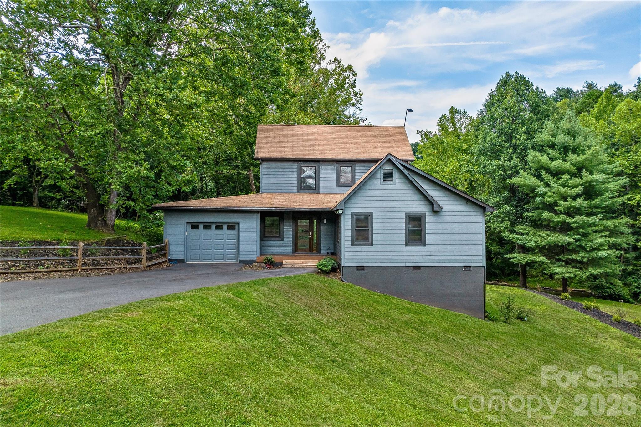 48 Merrell Road Leicester, NC 28748 - Photo 20 of 28 a view of a house with a yard and table and chairs under an umbrella
