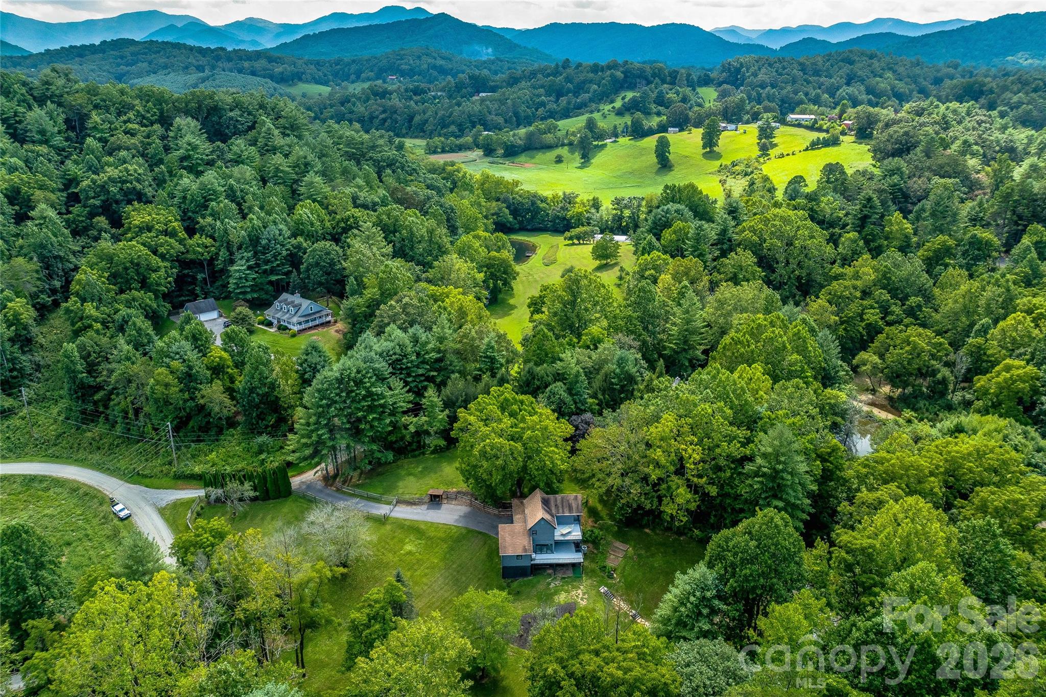 48 Merrell Road Leicester, NC 28748 - Photo 27 of 28 a view of a lush green hillside and houses