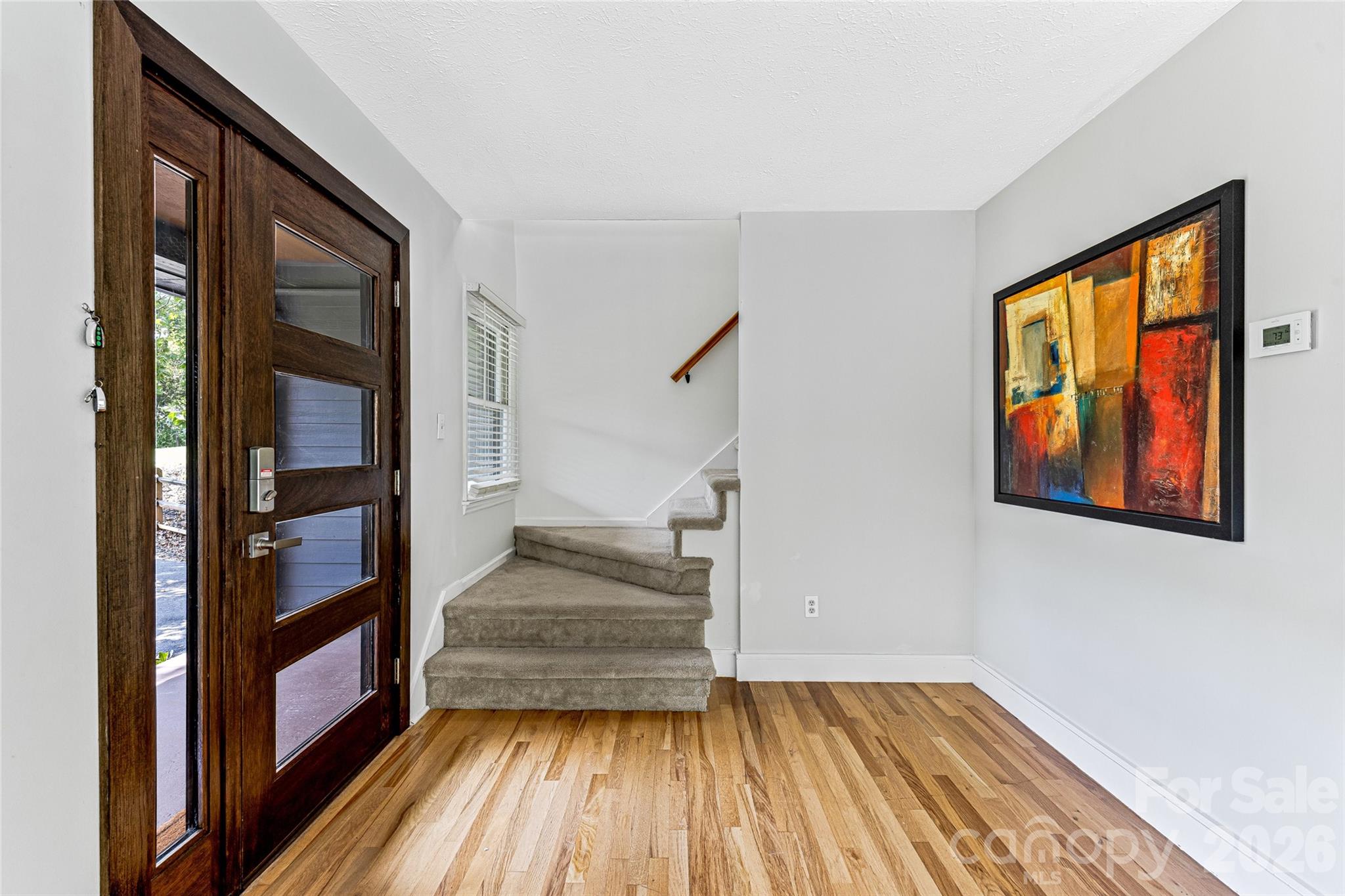 48 Merrell Road Leicester, NC 28748 - Photo 7 of 28 a view of an entryway with wooden floor and staircase