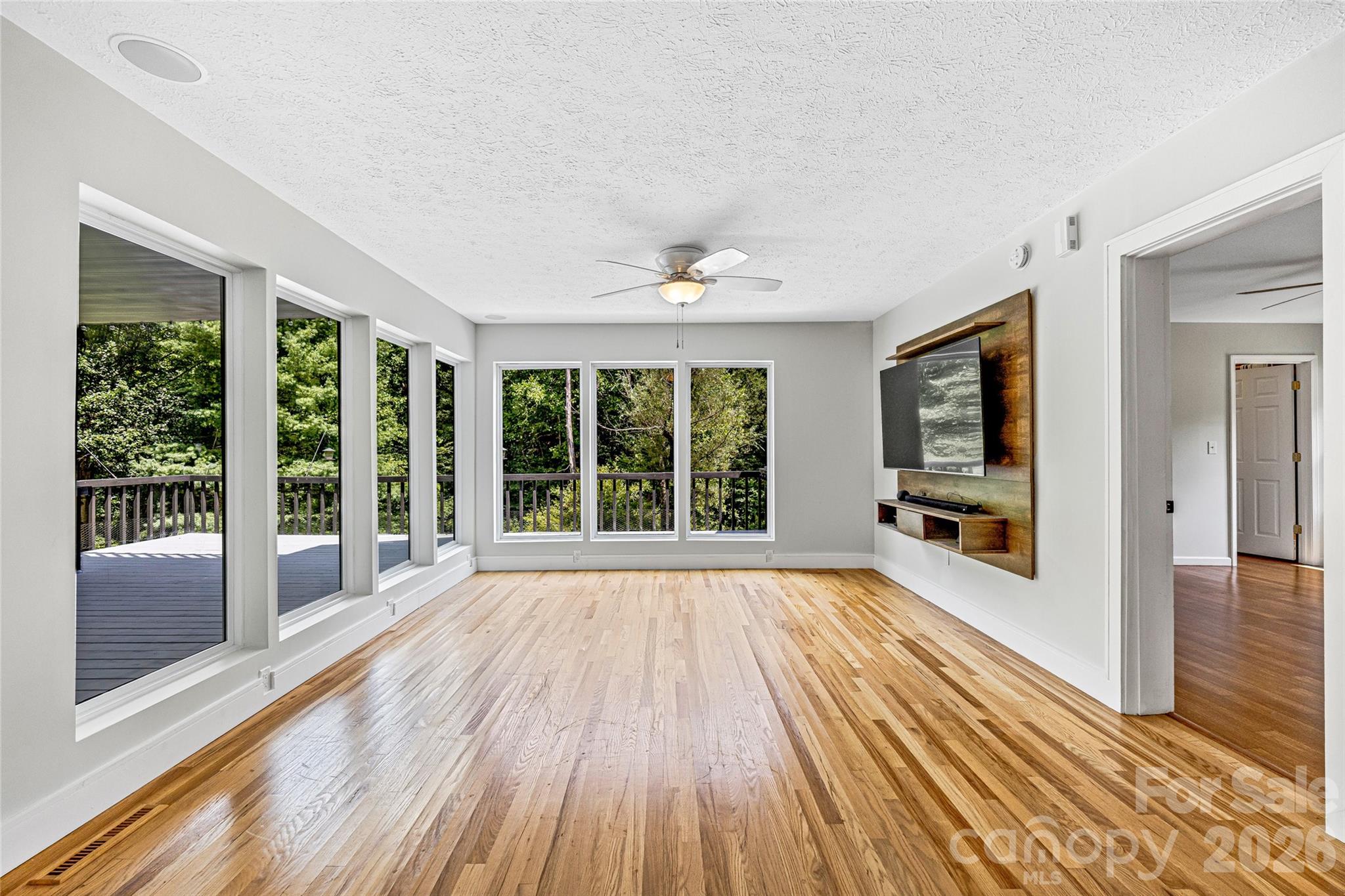 48 Merrell Road Leicester, NC 28748 - Photo 8 of 28 a view of an empty room with wooden floor and a window
