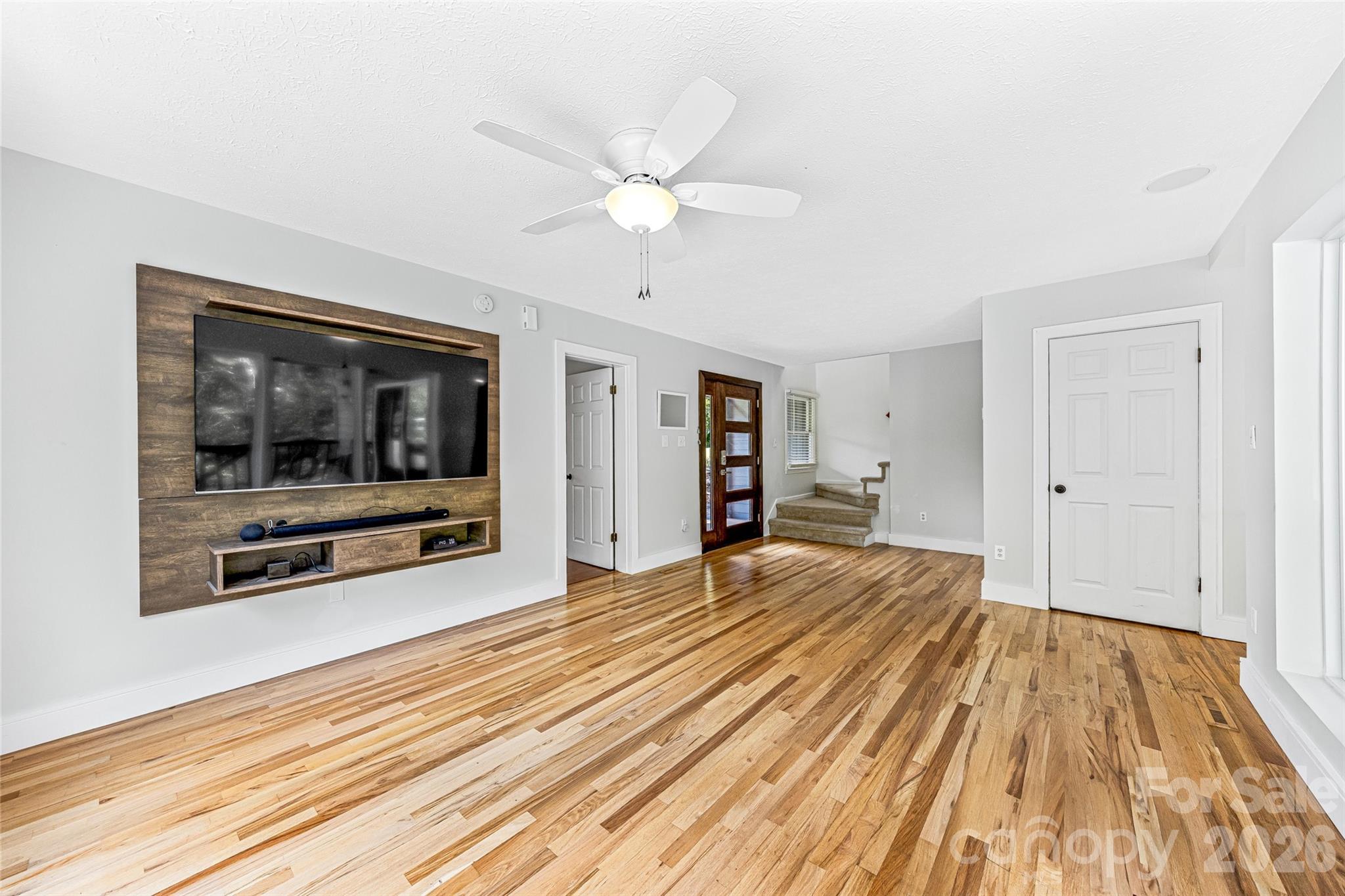 48 Merrell Road Leicester, NC 28748 - Photo 9 of 28 a view of empty room with wooden floor and fan