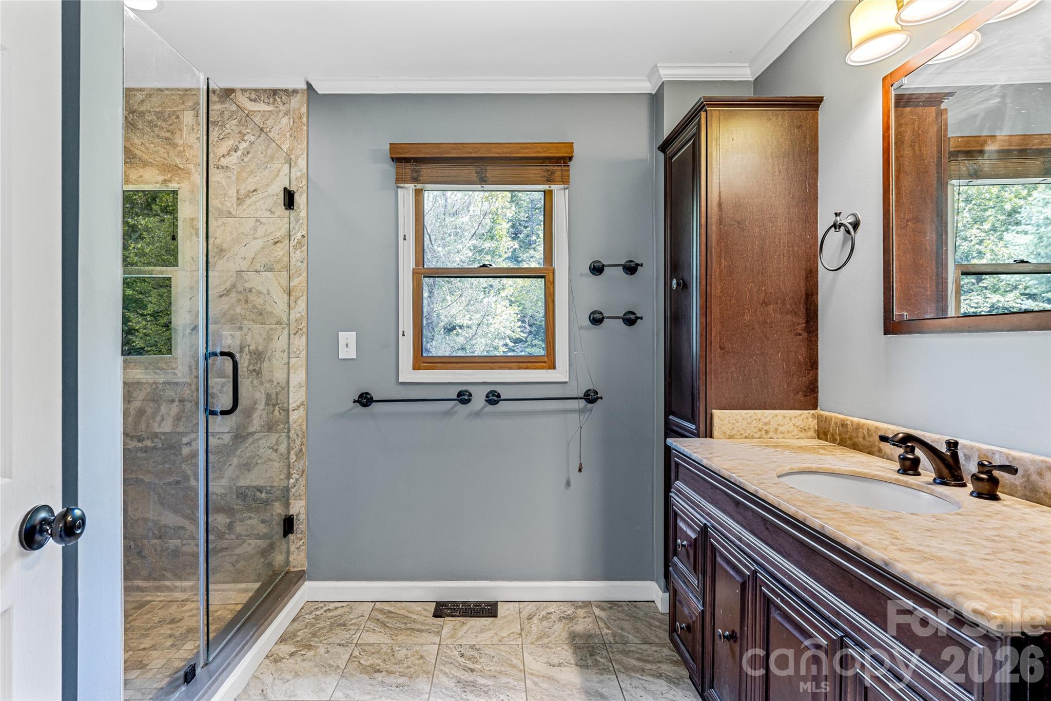 48 Merrell Road Leicester, NC 28748 - Photo 10 of 28 a bathroom with a granite countertop sink a mirror and a shower