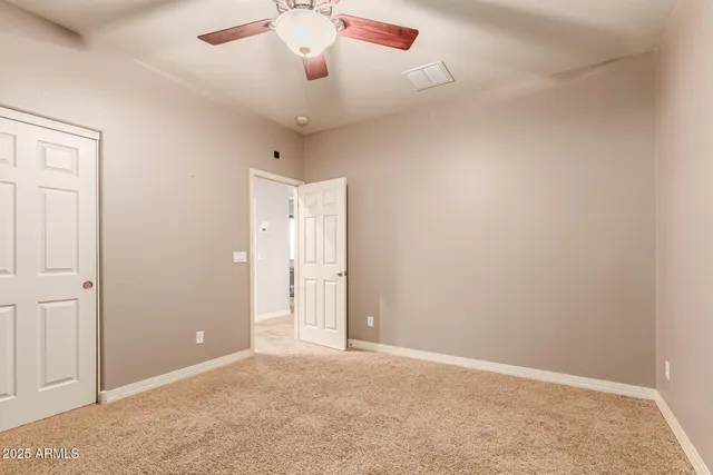 a view of a livingroom with a ceiling fan and window