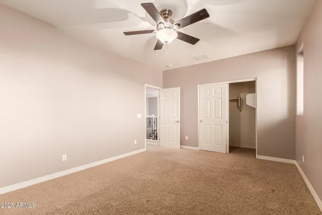 a bathroom with a granite countertop sink mirror vanity and toilet