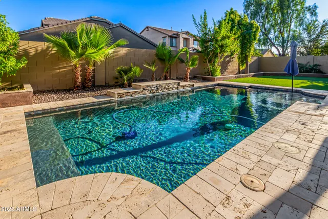an aerial view of a house with a yard and potted plants