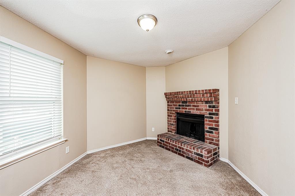 1401 Del Rio Drive Mesquite, TX 75149 - Photo 13 of 17 a view of an empty room with a fireplace and a window