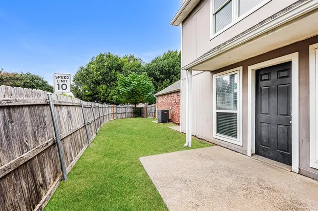 a view of a house with backyard and porch