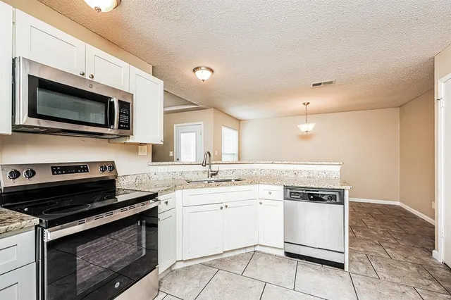 a kitchen with a stove and a microwave