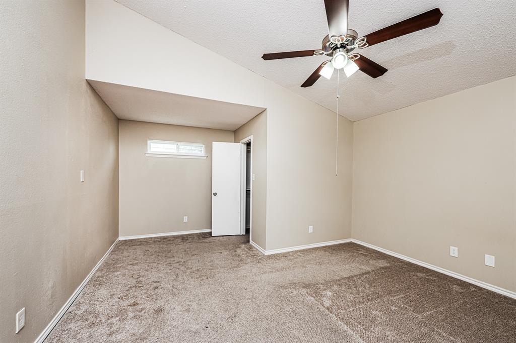 1401 Del Rio Drive Mesquite, TX 75149 - Photo 7 of 17 an empty room with a ceiling fan and carpet
