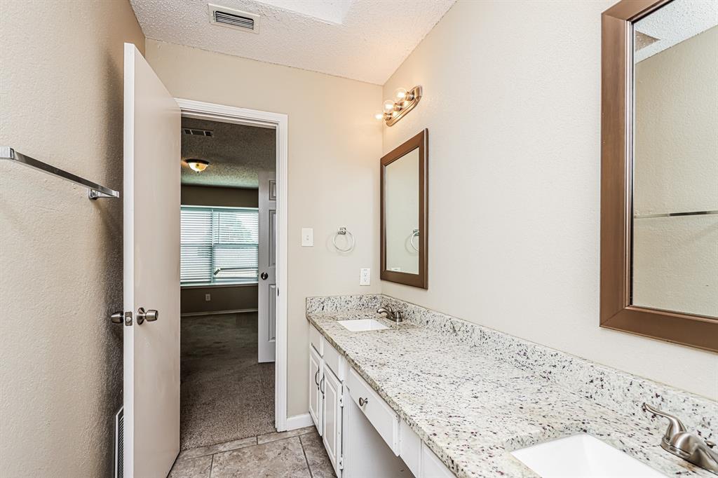 1401 Del Rio Drive Mesquite, TX 75149 - Photo 9 of 17 a bathroom with a granite countertop sink mirror and shower
