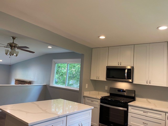 7 Treebark Court Schaumburg, IL 60193 - Photo 12 of 29 a kitchen with kitchen island white cabinets appliances and a window