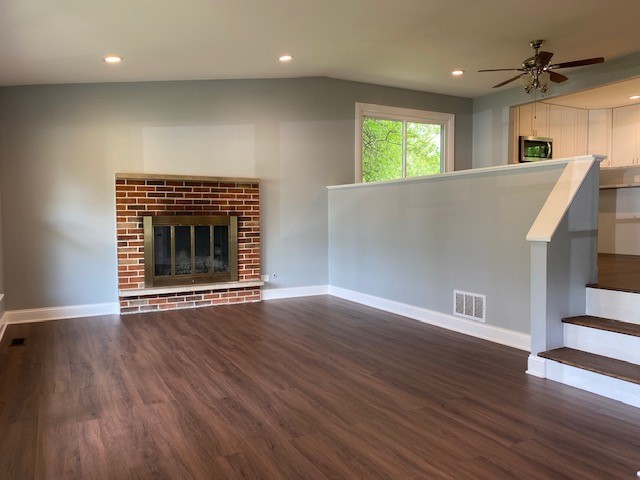 7 Treebark Court Schaumburg, IL 60193 - Photo 6 of 29 an empty room with wooden floor fireplace and windows