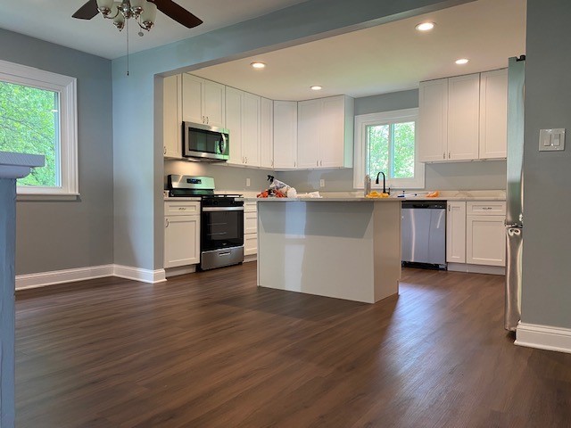 7 Treebark Court Schaumburg, IL 60193 - Photo 8 of 29 a kitchen with stainless steel appliances granite countertop a stove top oven a sink dishwasher a refrigerator and a microwave oven with wooden floor