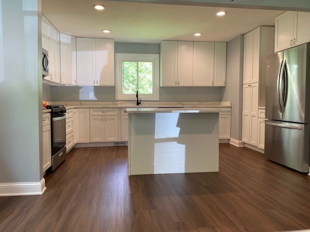 7 Treebark Court Schaumburg, IL 60193 - Photo 9 of 29 a kitchen with stainless steel appliances granite countertop wooden floors and white cabinets