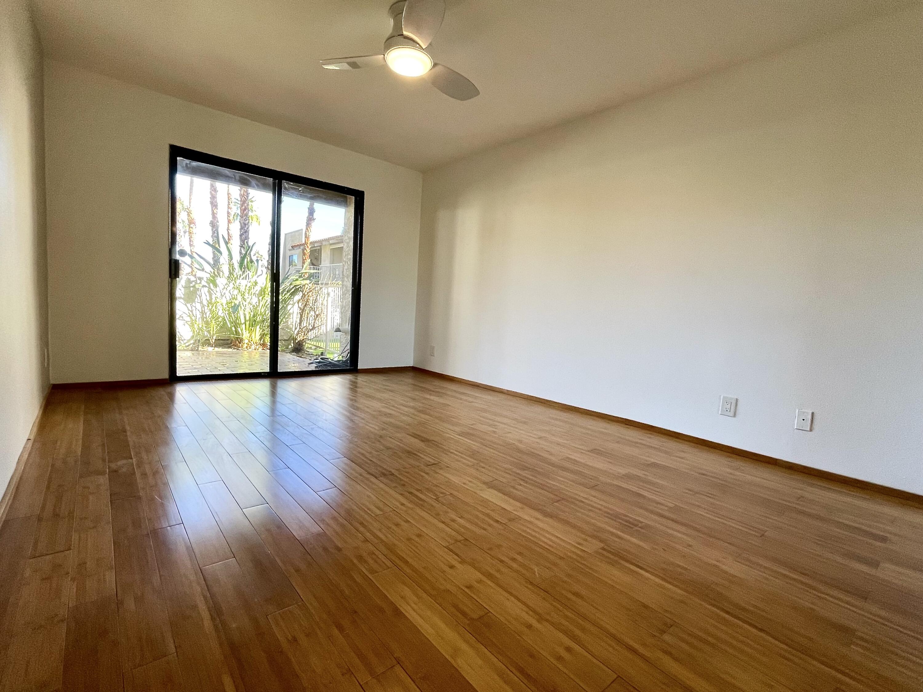 310 East San Jose Road, Unit 110 Palm Springs, CA 92264 - Photo 11 of 34 a view of an empty room with wooden floor and a window