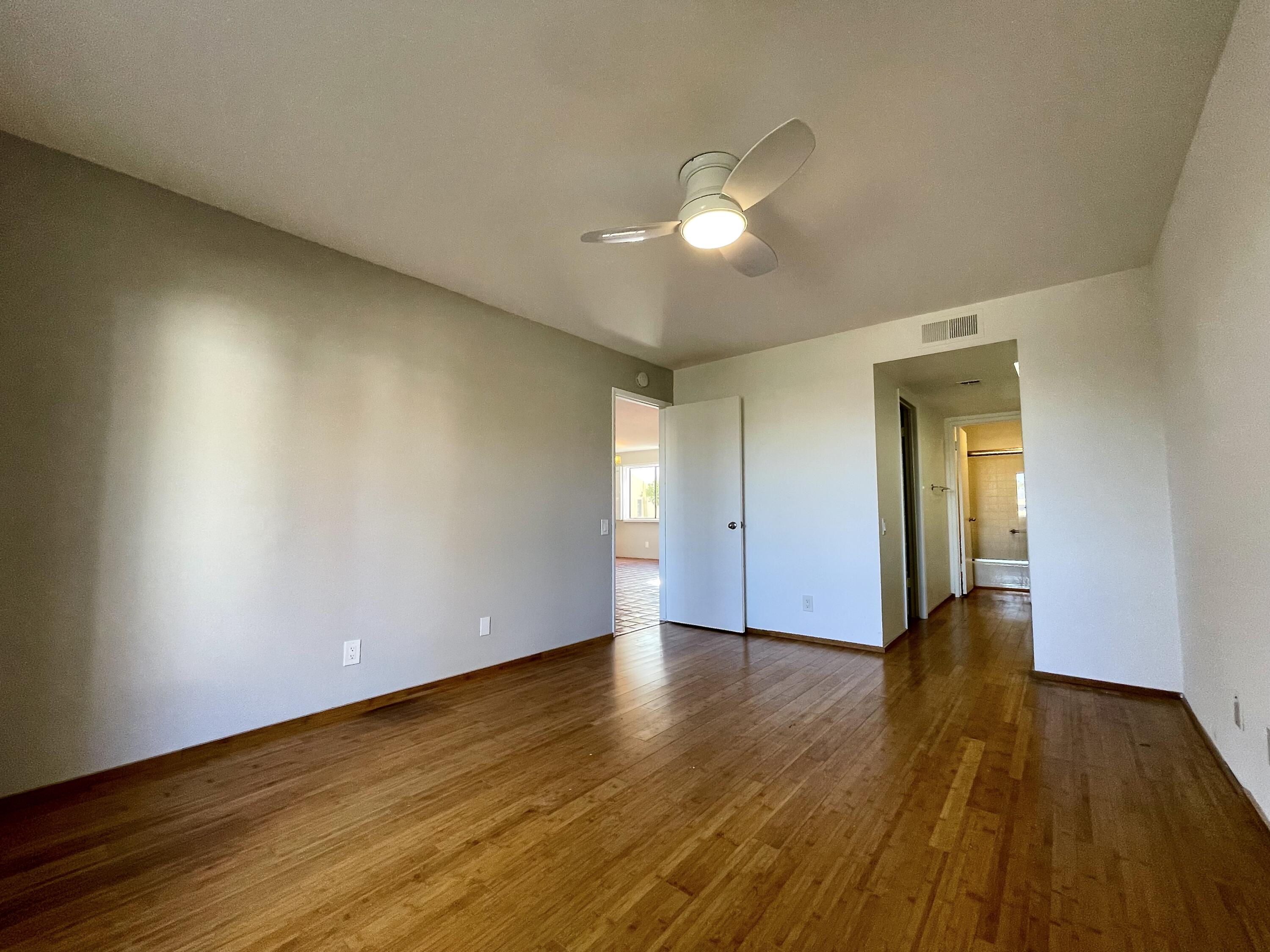 310 East San Jose Road, Unit 110 Palm Springs, CA 92264 - Photo 17 of 34 a view of an empty room with wooden floor and a window