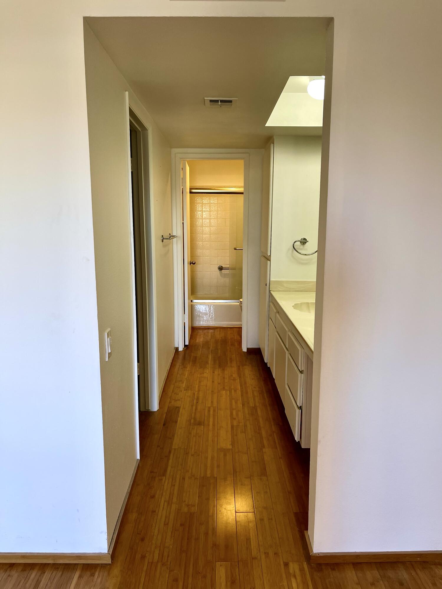 310 East San Jose Road, Unit 110 Palm Springs, CA 92264 - Photo 19 of 34 a view of a hallway with wooden floor and a bathroom