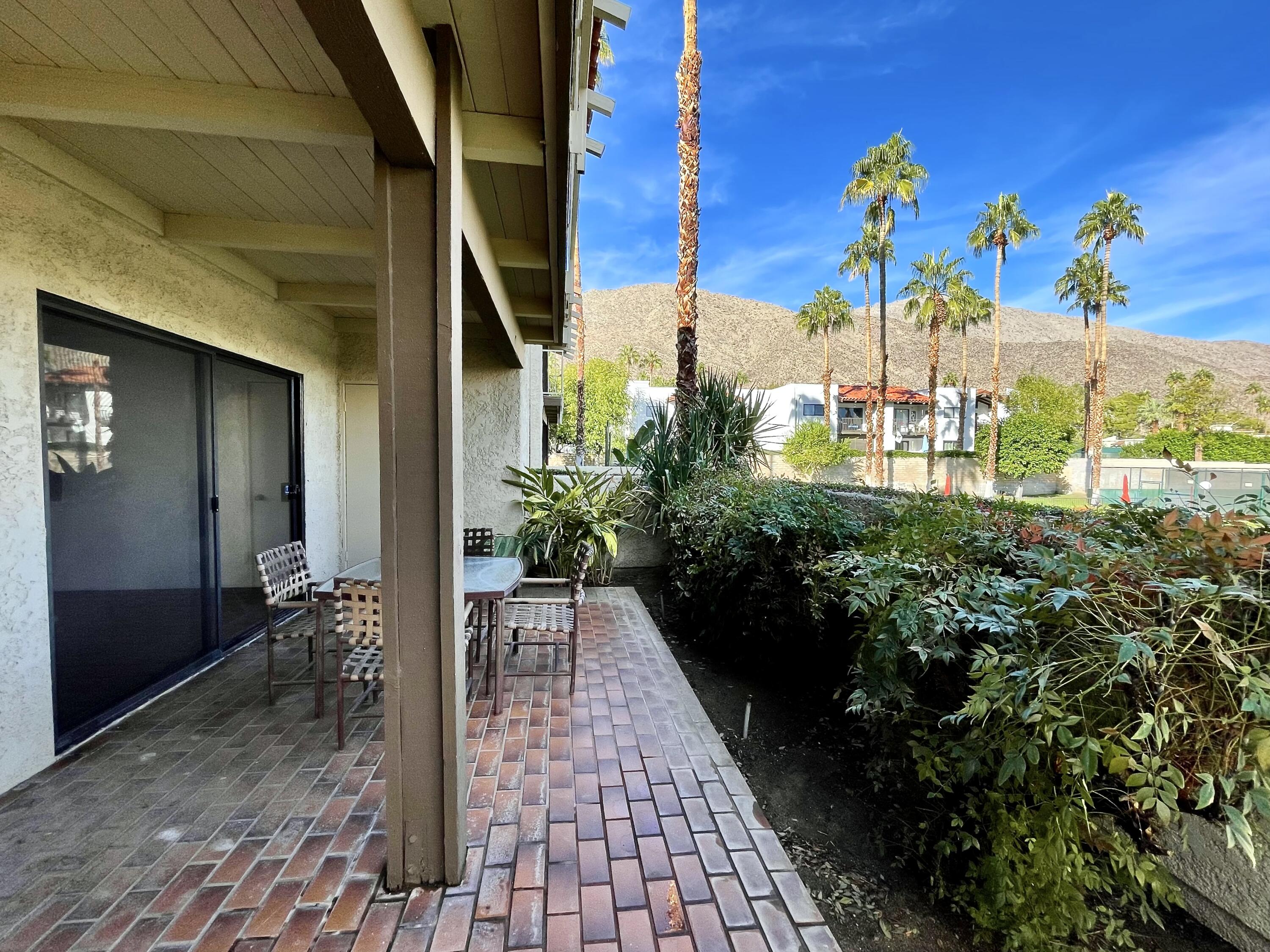 310 East San Jose Road, Unit 110 Palm Springs, CA 92264 - Photo 25 of 34 a view of a balcony with chairs and potted plants