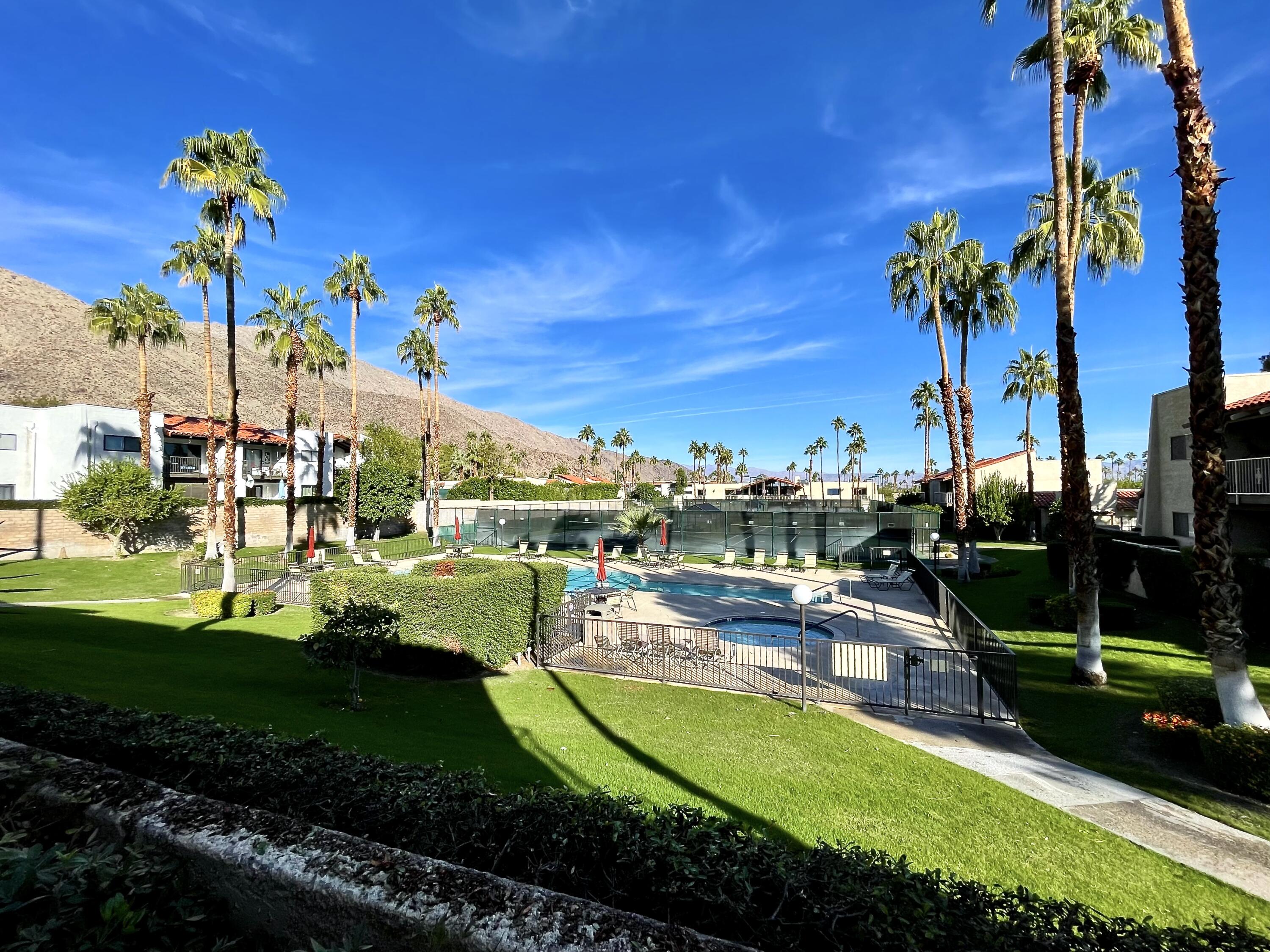 310 East San Jose Road, Unit 110 Palm Springs, CA 92264 - Photo 26 of 34 a view of a swimming pool with a garden