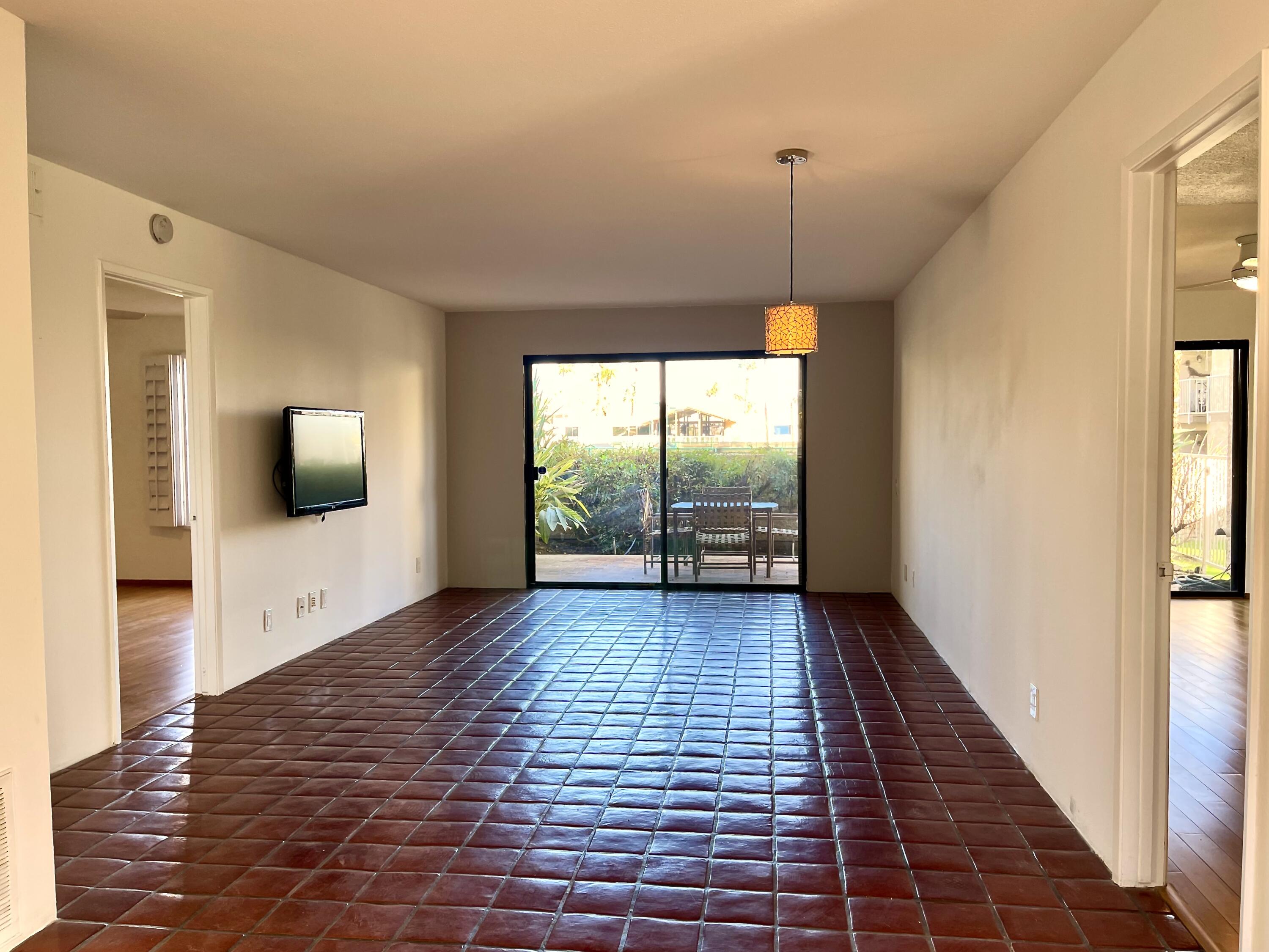 310 East San Jose Road, Unit 110 Palm Springs, CA 92264 - Photo 3 of 34 a view of a room with wooden floor an entryway and a window