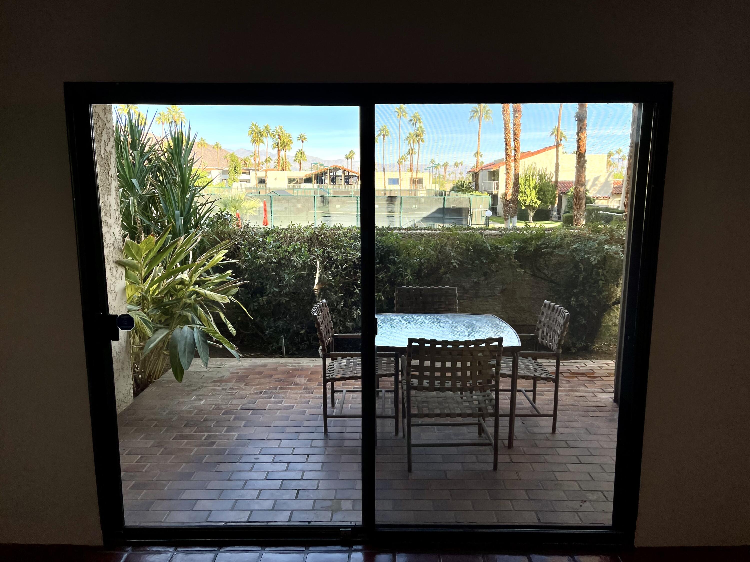 310 East San Jose Road, Unit 110 Palm Springs, CA 92264 - Photo 4 of 34 a view of a porch with chairs and backyard