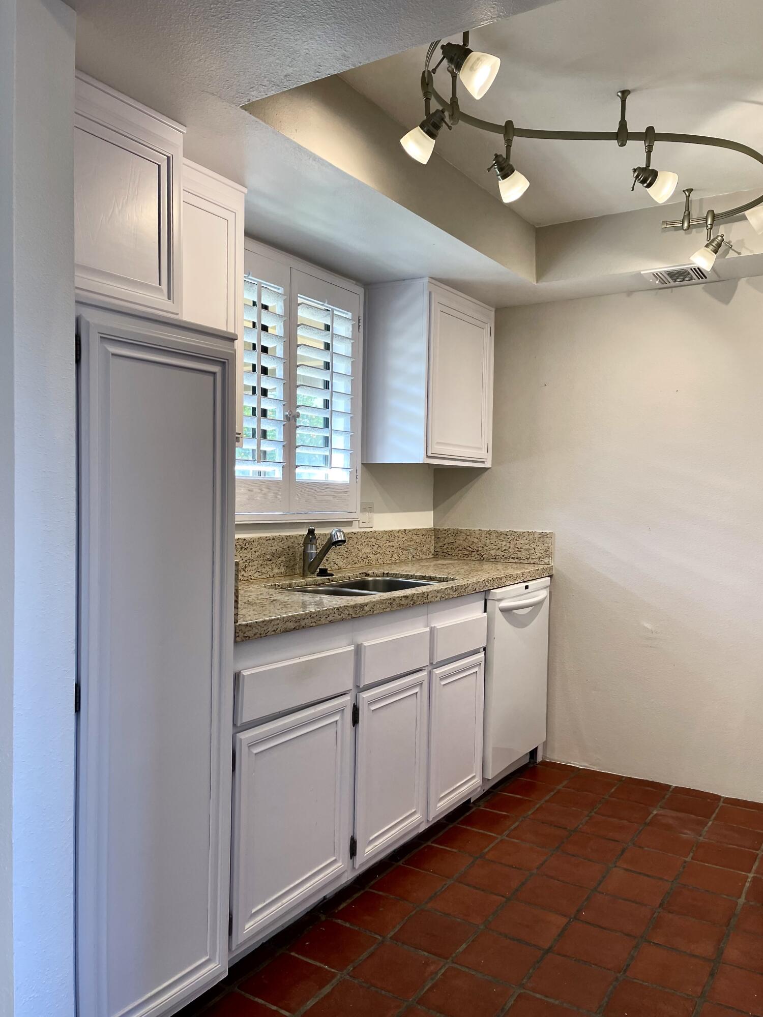 310 East San Jose Road, Unit 110 Palm Springs, CA 92264 - Photo 8 of 34 a kitchen with a sink cabinets and window