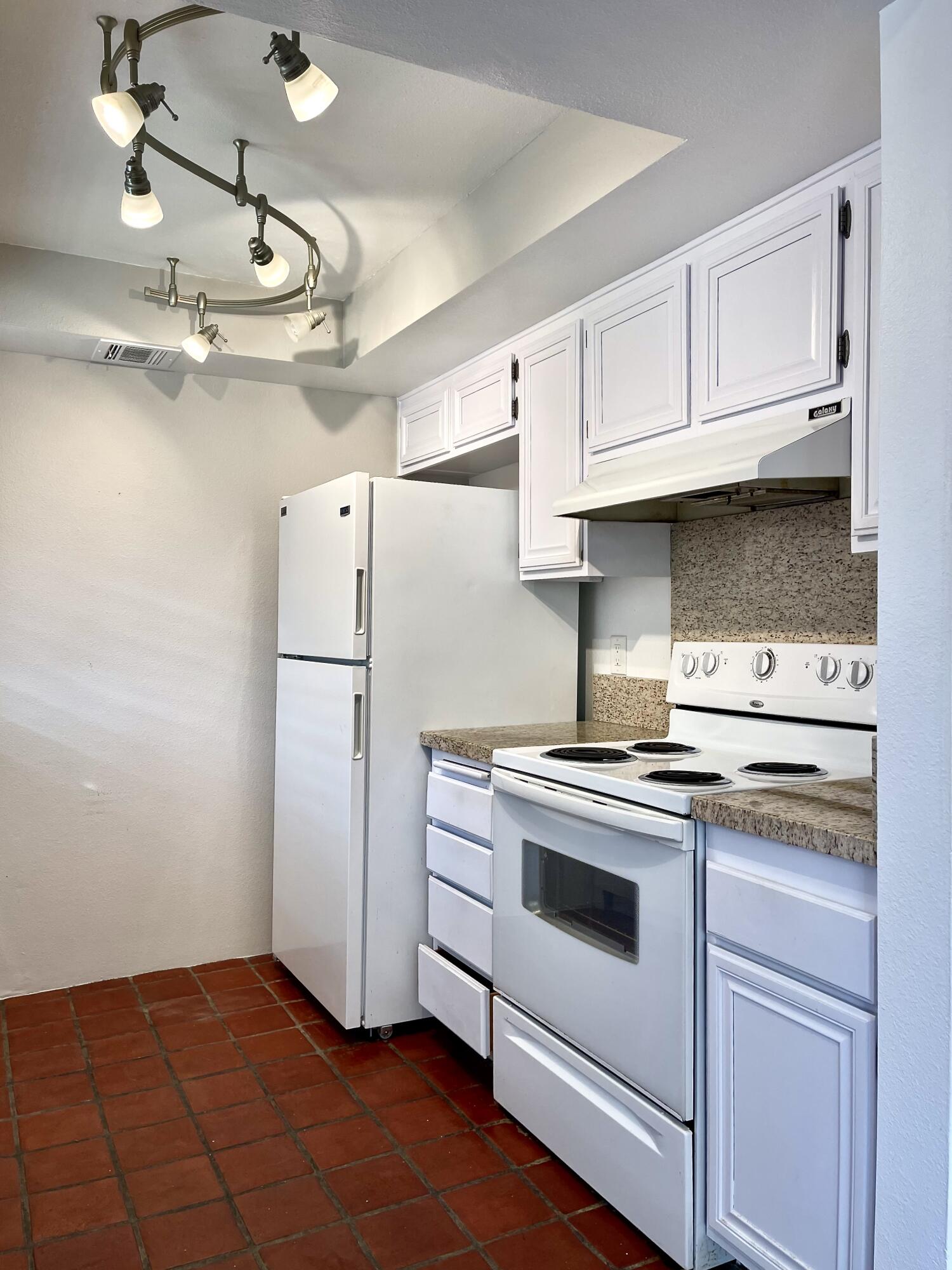 310 East San Jose Road, Unit 110 Palm Springs, CA 92264 - Photo 9 of 34 a kitchen with cabinets appliances and wooden floor