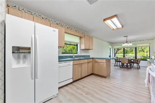 a kitchen with a refrigerator and a sink