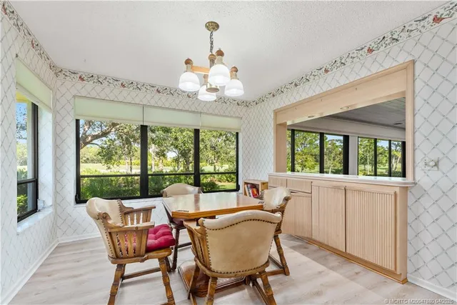 a dining room with furniture a chandelier and a rug