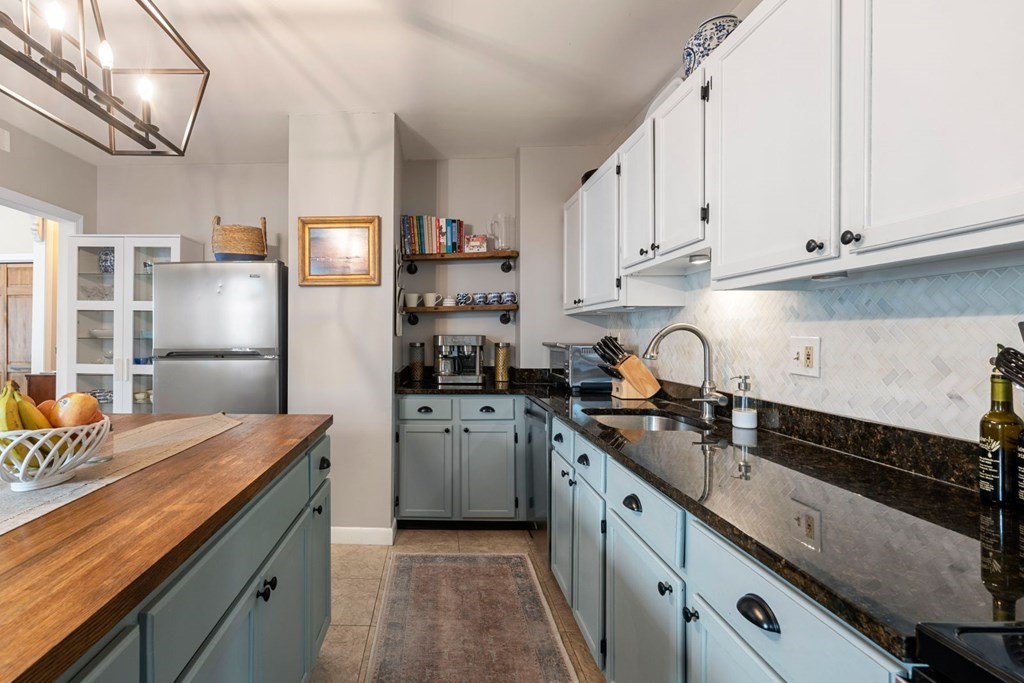 52 O Street, Unit 3 Boston, MA 02127 - Photo 5 of 15 a kitchen with stainless steel appliances granite countertop a sink stove and refrigerator