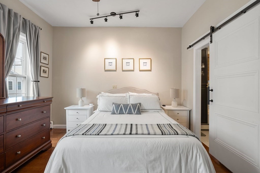 52 O Street, Unit 3 Boston, MA 02127 - Photo 6 of 15 a bedroom with a large bed and a window